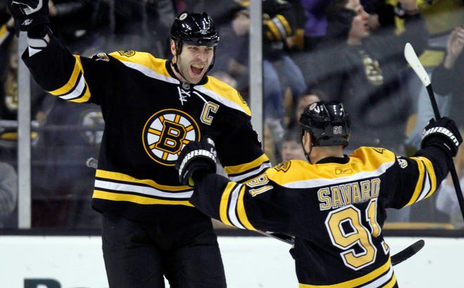 Zdeno Chara, left, celebrates his first goal of the first period with teammate Marc Savard during the Bruins' 7-0 win over Carolina on Monday at the Garden.