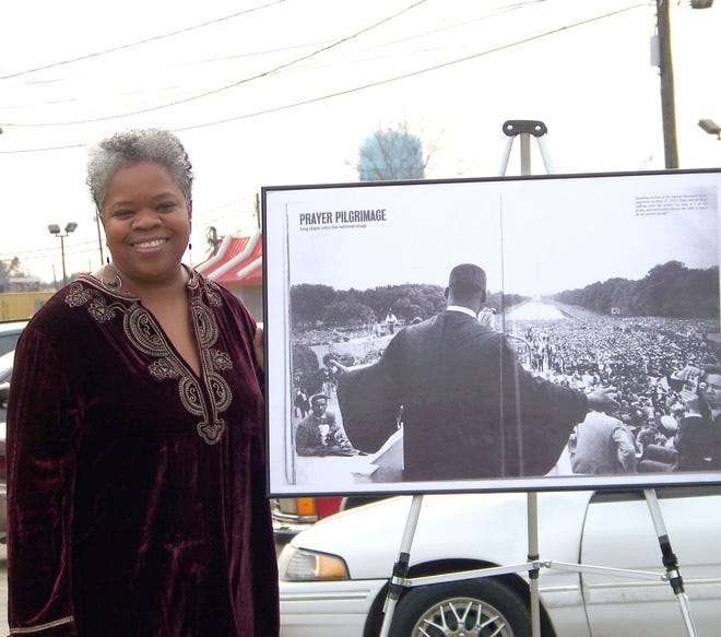 Kathe' Hambrick-Jackson poses with a photo of Dr. Martin Luther King Jr. at his Prayer Pilgrimage.