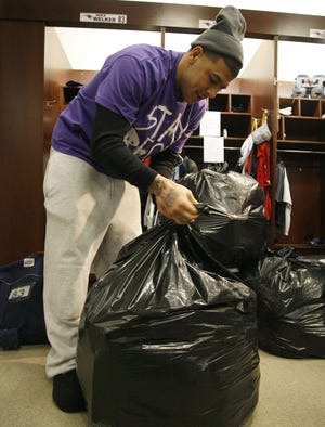 Patriots tight end Aaron Hernandez packs up his belongings in the team's locker room one day after New England was eliminated from the playoffs by the Jets.