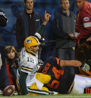 Packers quarterback Aaron Rodgers signals his touchdown during Monday night's NFL game at Soldier Field.