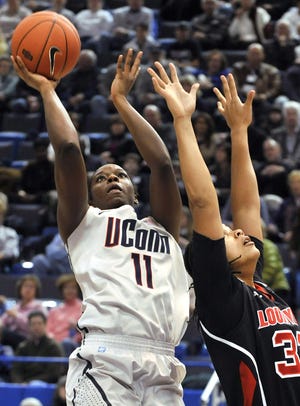 Connecticut's Samarie Walker goes up for a basket while guarded by Louisville's Monique Reid during the first half of an NCAA college basketball game, in Hartford, Conn., Saturday, Jan. 15, 2011.