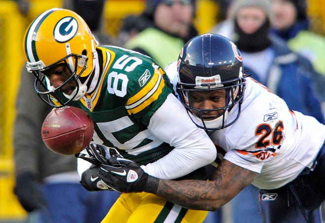 The Chicago Bears' Tim Jennings breaks up a pass intended for the Green Bay Packers' Greg Jennings (85) during the first half of an NFL football game Sunday, Jan. 2, 2011, in Green Bay, Wis.