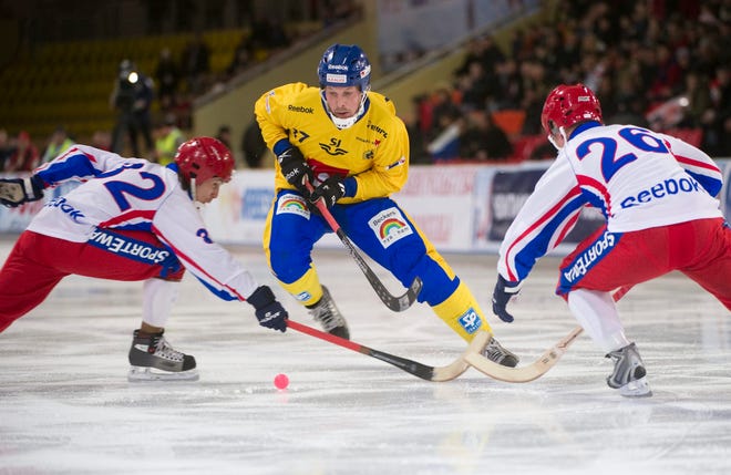 Sweden's Daniel Mossberg (center) worked against two Russian defenders during last year's finals of the World Bandy Championships. Bandy resembles field hockey, but on skates.