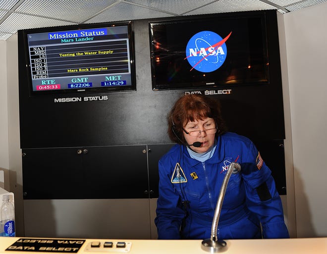 Flight director Gail Corey works in the Mars Lander during a visit by Ashland Middle School students at the Christa Corrigan McAuliffe Center in Framingham Thursday.