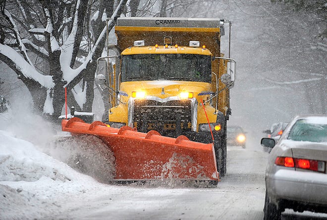 File photo: A plow makes its way up Pine Hill Road in Framingham.