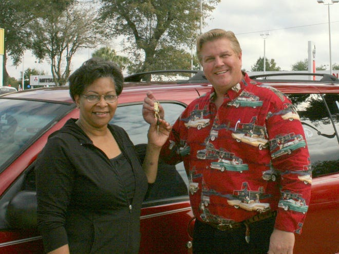 Beverly Tindale, winner of a new Mercury Villager mini-van donated by Prestige Auto Sales, receives the keys from Prestige president Chris Spears.