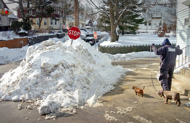 As storm after storm has hit the region, a snow bank has been growing toward the top of a stop sign on Garfield Street in Quincy. The photo was taken on Saturday, Jan. 22, 2011.