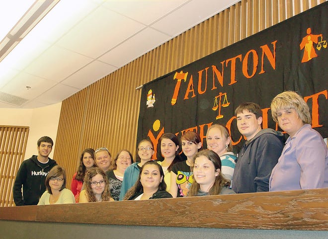 Members of Taunton Youth Court are trying to secure funding for the program to continue. Seated, from left, are Alysha Teixeira, Amy Starvish, Ashley Sousa and Stephanie Delzell. Standing, from left, are Matt Chaves, Savannah Castello, 
Alexandria Colbert, Jillian DeSousa, Lillian Cabral, Alexandra Bowden, Gabriella Barth, Amanda Brown, Derrek Joyce and program director Lisa DaPonte.