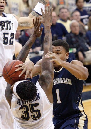 Notre Dame’s Tyrone Nash (1) loses the ball as he tries to shoot over Pittsburgh’s Nasir Robinson (35) during their game Monday in Pittsburgh. Robinson was called for a foul on the play. Notre Dame upset No. 2 Pittsburgh, 56-51.