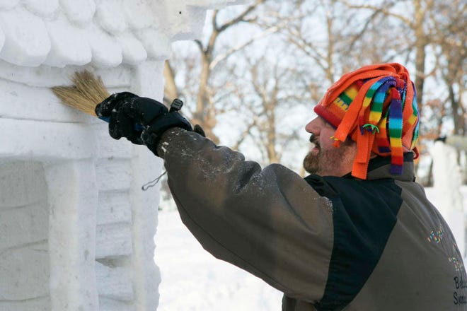 Gary Simon uses a brush Friday, Jan. 21, 2011, on his team’s sculpture, “Just Doing What Comes Natural,” for the 25th annual Illinois Snow Sculpting Competition at Sinnissippi Park in Rockford.