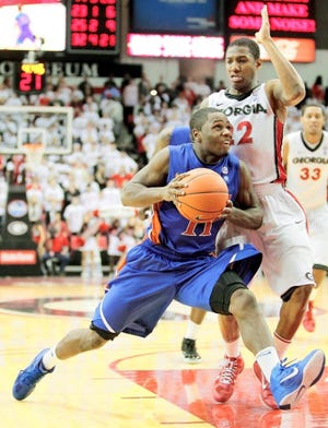 Florida guard Erving Walker (11) drives on Georgia guard Gerald Robinson (22) during Tuesday's 104-91 Florida win in double overtime. The Associated Press