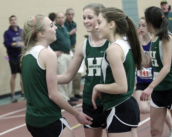 Hopkinton's Melissa Lodge (left) is congratulated by teammates after running the last leg of the 4x400 relay during the Hillers' TVL-clinching win over Medfield yesterday.