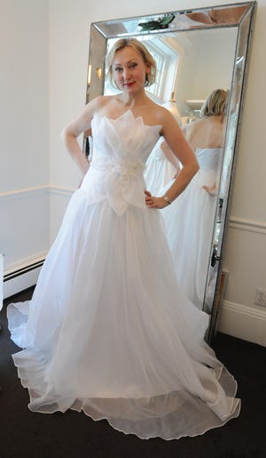 Anna Nieman of Anna Nieman Bridal in Brookline models "Annette" a silk organza full pleated skirt with a floral applique.

Keith E. Jacobson/CNC Staff Photographer