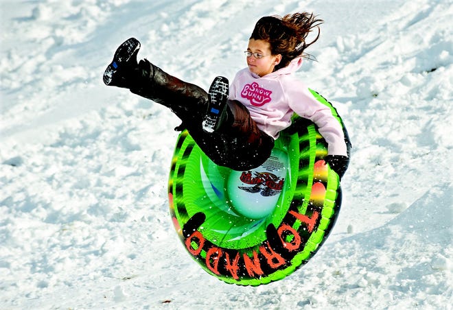 Kristen Weaver, 11, of Luray, Va., catches some air while sledding on her day off from school down the hill at the Luray High School Thursday, Jan. 27.