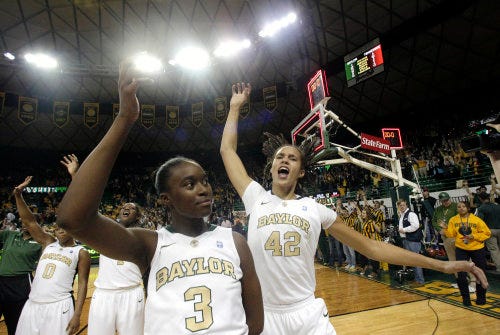 Baylor players Odyssey Sims (0), Kimetria Hayden, Jordan Madden (3) and Brittney Griner (42) celebrate their 65-54 win against Tennessee last month in Waco. Baylor is ranked No. 1 in the country and riding a 15-game winning streak.
