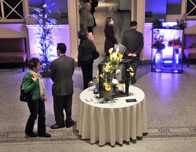 Guests admire floral displays at the opening this week of the Worcester Art Museum's ninth annual “Flora in Winter” professional floral design show.
