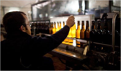 A worker checks the production line. The brewery’s Vergina beer has a 5.5 percent share of the Greek market.
