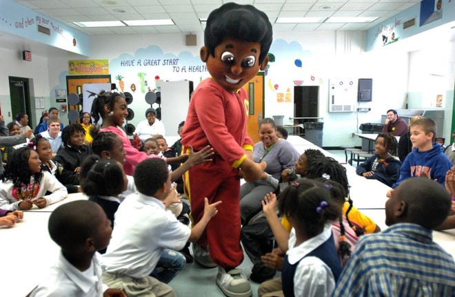 Cornbread makes his entrance Friday during a literacy presentation at Long Branch Elementary that concluded Literacy Week at the school. Cornbread is a character in three children's books.