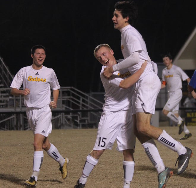 St. Amant's Beau Nickel and Rantz Bourgeois celebrate after a goal against East Ascension Friday night at the Pit. The Gators took a 2-1 win.