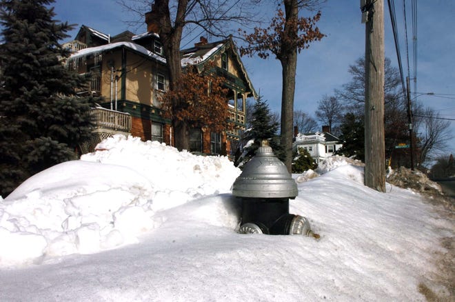 A hydrant is buried in the snow on West Elm Street in Brockton on Monday.