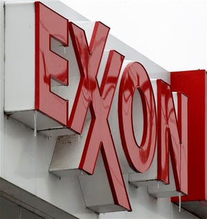 In this Jan. 27 photo, an Exxon sign is displayed atop a mini-market in Carnegie, Pa. Exxon said Monday net income grew 53 percent in the fourth quarter as oil prices rose and the company increased production.