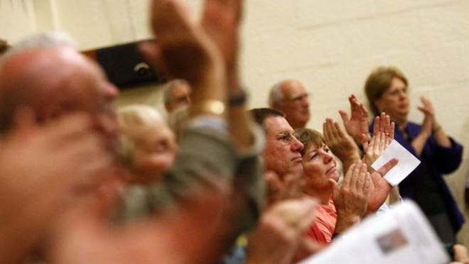 Audience members applaud U.S. Representative Allen West during a town hall meeting at St. Mark Catholic School Monday Jan. 31, 2011.