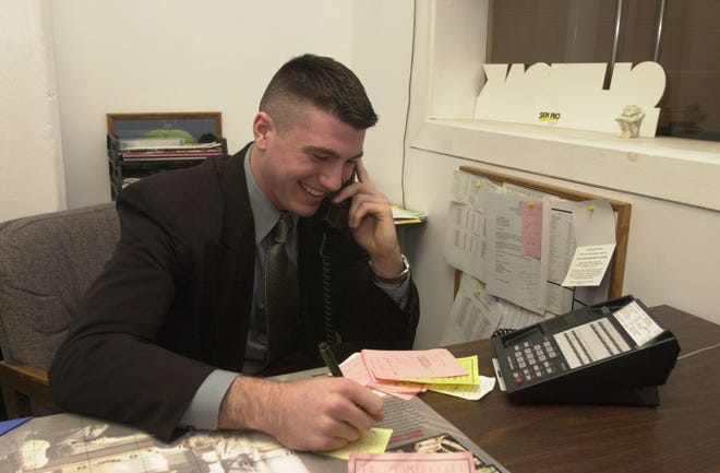 GlenOak High School senior Dustin Fox talks on the phone with Ohio State head coach Jim Tressel on national signing day in February 2006.
