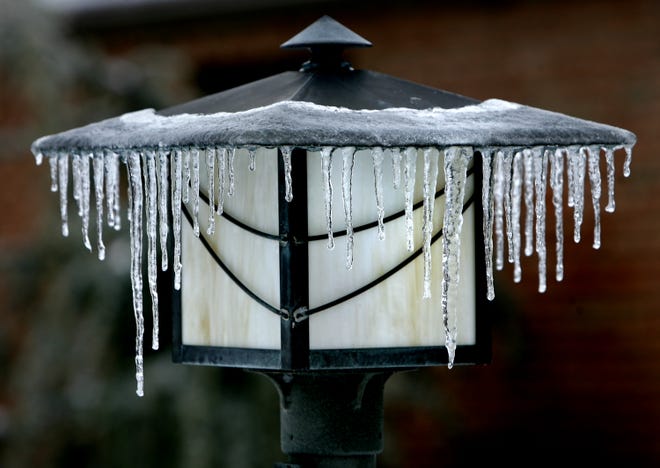 Icicles form on a lamp during the freezing rain in Jackson Twp.