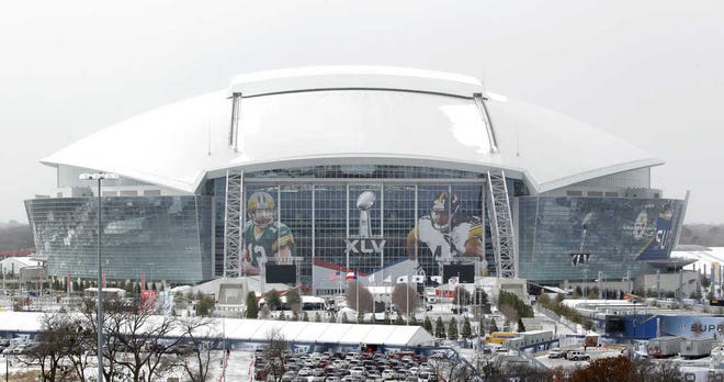 Sleet sits on top of Cowboys Stadium as a light snow falls on Tuesday in Arlington. Temperatures dipped into the single digits Tuesday, and the week’s forecast called for similar temperatures with a slight warm-up for Super Bowl XLV, which will be played Sunday between the Green Bay Packers and Pittsburgh Steelers.