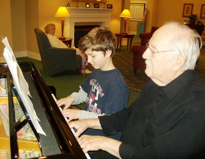 Marc Beaulieu, right, a former music teacher, gave a piano lesson recently to David Wollensak, a member of the Hopedale Elementary Student Council. Once a month, students from the student council visit with the residents of Atria Draper Place.
CONTRIBUTED PHOTO