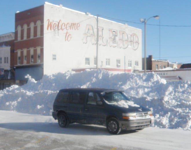 Snow is piled higher than this van Thursday, Feb. 3 as the city digs out from Tuesday night's blizzard.