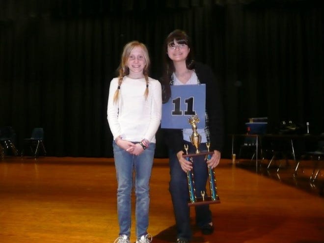 After 35 rounds, Ashlie Malone (right), a sixth-grader at Landon Middle School, correctly spelled "kavya," a Sanskrit form of poetry, to win the Duval County Spelling Bee. At left is runner-up Julia Sessions, a fifth-grader at San Jose Episcopal Day School.