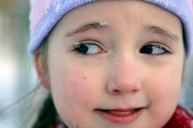 Snow crystals cling to Laynie Goodwin, 6, after sledding in Bradley park with her family Thursday afternoon.