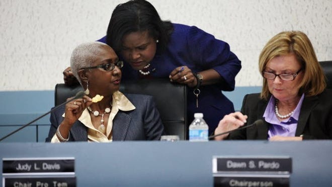 Riviera Beach City Attorney Pamala Ryan speaks with Chair Pro Tem Judy Davis next to Chairperson Dawn Pardo Wednesday, Feb. 2, 2011. Several members of the city council were served with summons earlier.