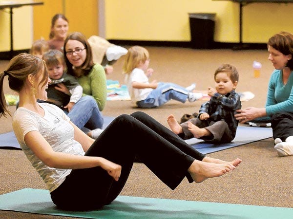Susan Wood, left, teaches a family yoga story time at the Northeast Regional Library in Wilmington Friday, January 21, 2011.