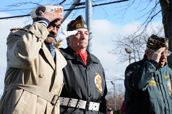 Pearl Harbor Survivor Ernest Wilkins, with former Randolph Veterans Agent Jim Campbell and Leo Jacobson to his right, salutes to honor all Veterans who have passed away during Randolph's Veterans Day services in November 2010. Wilkins died at his home Tuesday, Feb. 1.