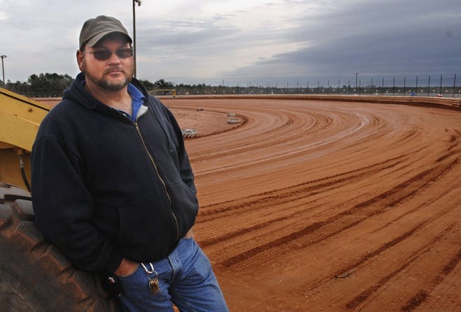 Darryl Courson leans against the motor grader he uses to smooth the dirt track at Golden Isles Speedway in Waynesville. Courson, the track manager, says he hopes the weather won't keep too many people away from the track for this weekend's Super Bowl of Racing, a big event for dirt-track drivers.