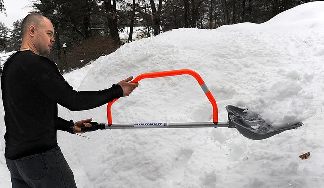 John Mosher of Hopkinton demonstrates his SnowBow ergonomic snow shovel.