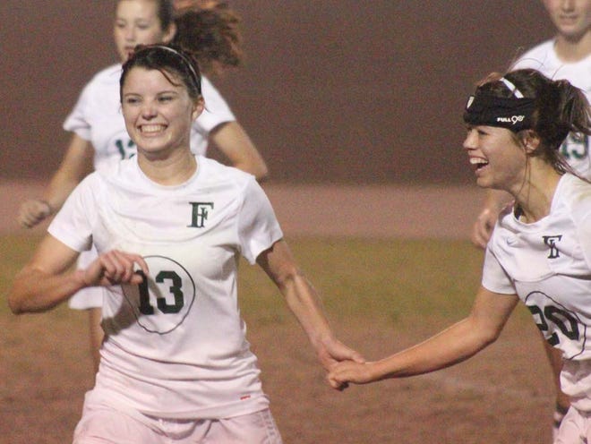 Fleming Island High School teammates Emma Cooke (13) and Alanna Phillips celebrate after the Golden Eagles won the Region 1-5A championship with a 1-0 win Friday.
