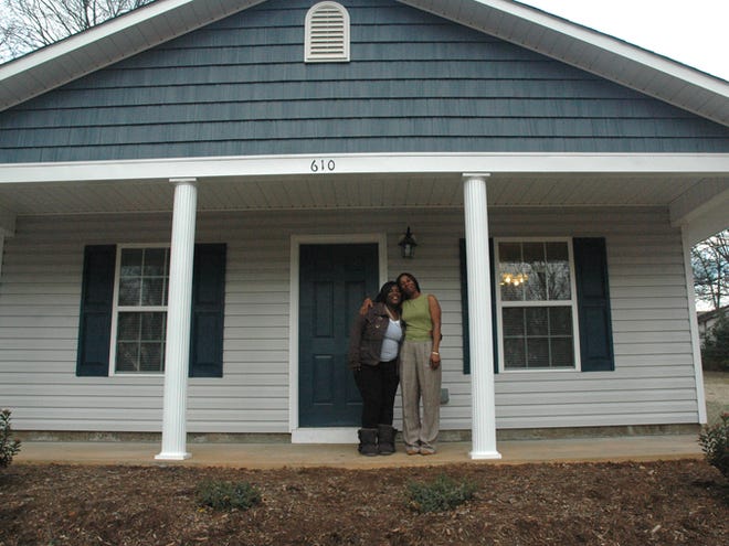 Alberta Smoker, right, and her daughter, Diamonde, stand on the porch of their new Habitat home in Spartanburg. R.L. Jordan Oil Co./Hot Spot funded the work to build the home.