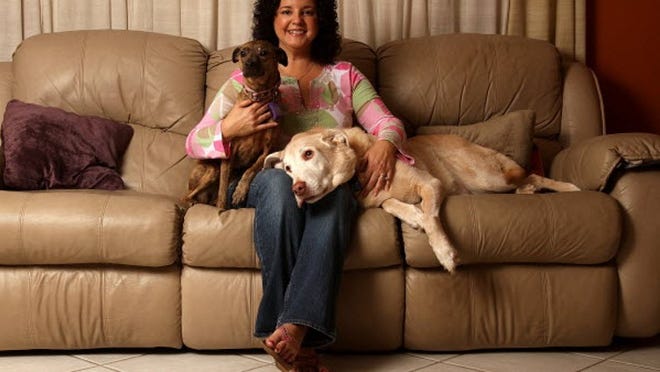 Mercy Carney of Lake Worth poses for a portrait with her dogs Roxy, left, and Riley, right. She is the owner of "Pet Meals on Wheels," an all-natural dog and cat food delivery business.