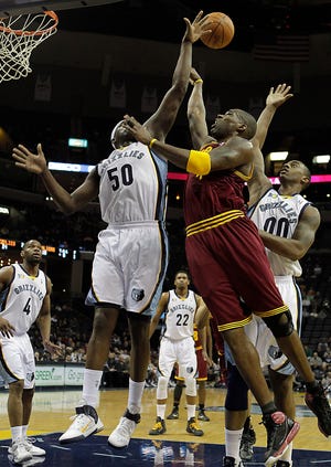 Cleveland Cavaliers forward Antawn Jamison (4) goes to the basket against Memphis Grizzlies defenders Zach Randolph (50) and Darrell Arthur (00) during the first half of Friday's game in Memphis.