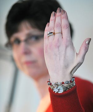 Donna Procopio displays the bracelets she makes.