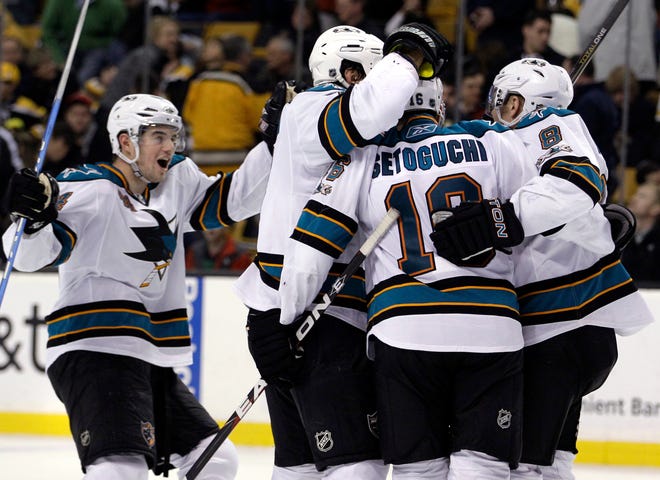 San Jose Sharks defenseman Marc-Edouard Vlasic, far left, joins other teammate to celebrate right wing Devin Setoguchi's goal during the last seconds of the third period of a NHL hockey game against the Boston Bruins in Boston Saturday, Feb. 5, 2011. The Sharks won 2-0. (AP Photo/Elise Amendola)