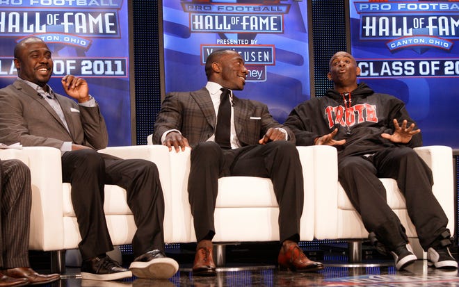 Members of the NFL Football Hall of Fame 2011 class, from left, Marshall Faulk, Shannon Sharpe and Deion Sanders, share a laugh while being interviewed following the announcement, Saturday, Feb. 5, 2011, in Dallas. (AP Photo/Tony Gutierrez)