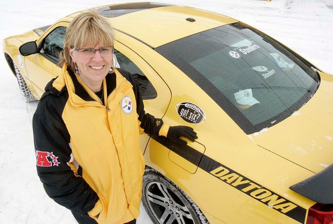 Tracy Patrick, South Beloit city clerk, stands next to her 2006 Dodge Charger decorated in Steelers colors on Tuesday, Feb. 1, 2011.