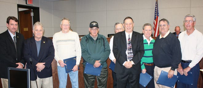 Six members of the 1957 Gonzales High School boys basketball state championship 1A team are shown receiving parish certificates of achievement at the Jan. 20 parish council meeting in Gonzales. Shown from left are: Parish Councilman Dempsey Lambert, Parish Council Chairman Pat Bell, Pat Arceneaux, Butch Ricca, Dan Causey, Parish President Tommy Martinez, Red Loupe, Glynn Gautreau and Jewell Gautreau. Players not able to attend included: Donald Richardson, Carlyn Gaudin, Alton Delaneuville, Lionel Glaze and Norris Decoteau. Head Coach Joel “Shank” Meredith, Assistant Coach Tom Harp and player Jerry Herald are deceased.