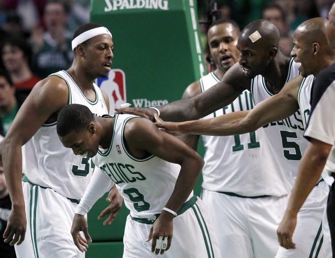 Celtics point guard Rajon Rondo (9) is congratulated by teammates during the second half of yesterday's win over the Magic. Rondo scored 26 points in the victory.