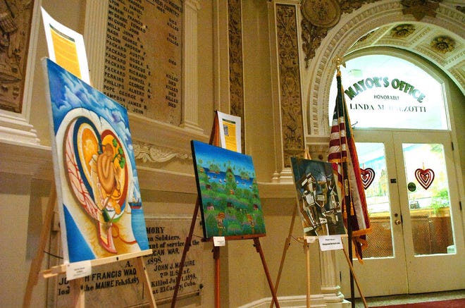 Artwork from Haitian artists, part of the exhibit “When Our Brushes Shook: A Multi-Site Collaborative Art Exhibition in Memory of Haiti’s Earthquake Victims,” sits outside Mayor Linda Balzotti’s office in Brockton City Hall.