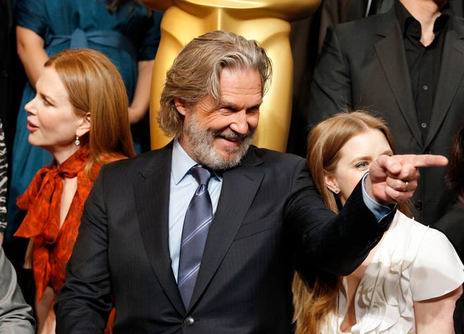 Nicole Kidman, left, Jeff Bridges, and Amy Adams pose for a group pictures at the 30th Academy Awards Nominees Luncheon in in Beverly Hills, Calif., Monday, Feb. 7, 2011. (AP Photo/Chris Carlson)